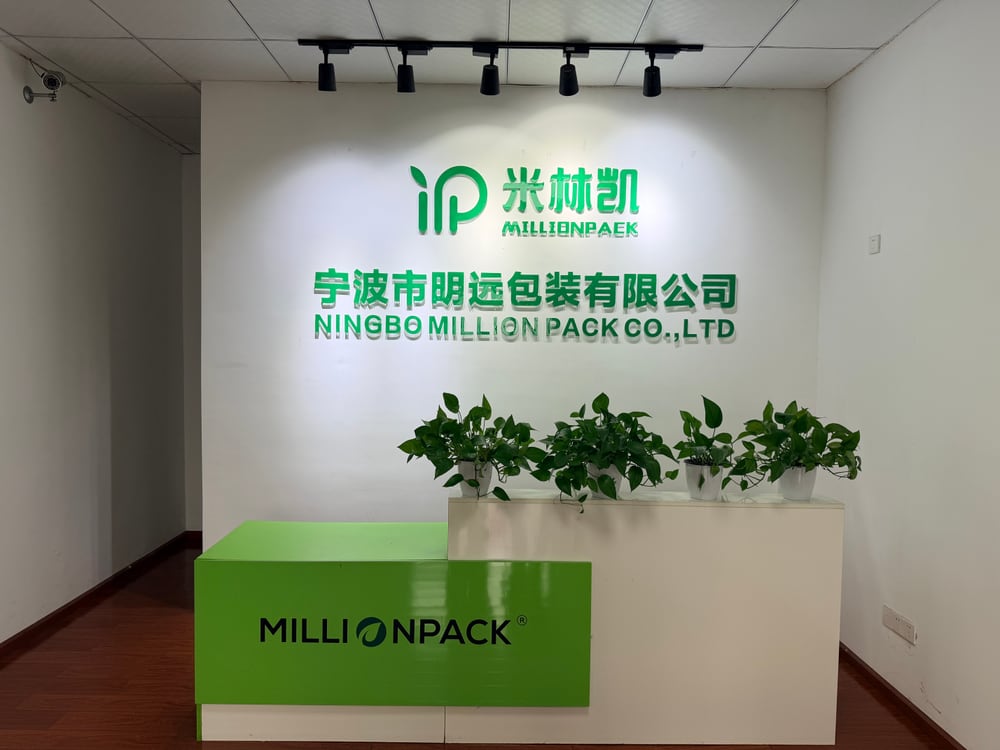 Million Pack office reception with the company logo wall and green reception desk