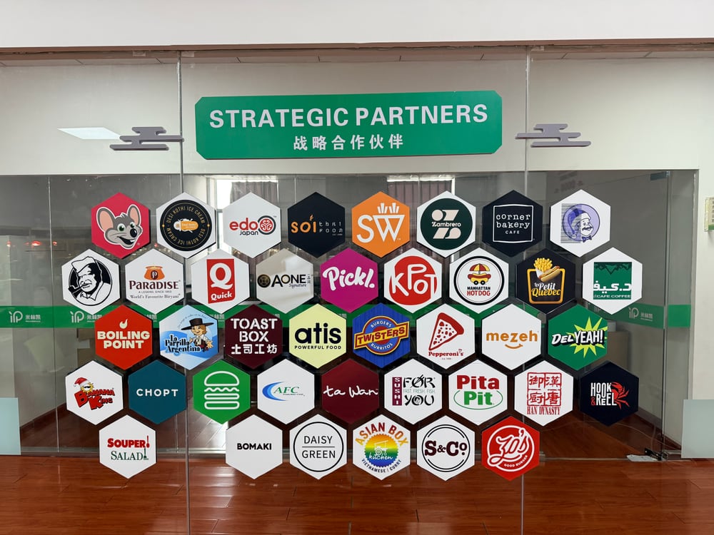 Partner logo display photographed inside the Million Pack office