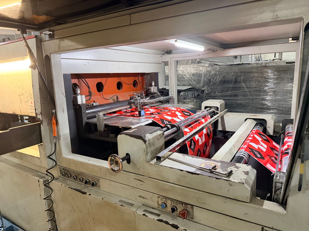 Wilson Wang Profile 13 Printed packaging paper passing through rollers on factory equipment